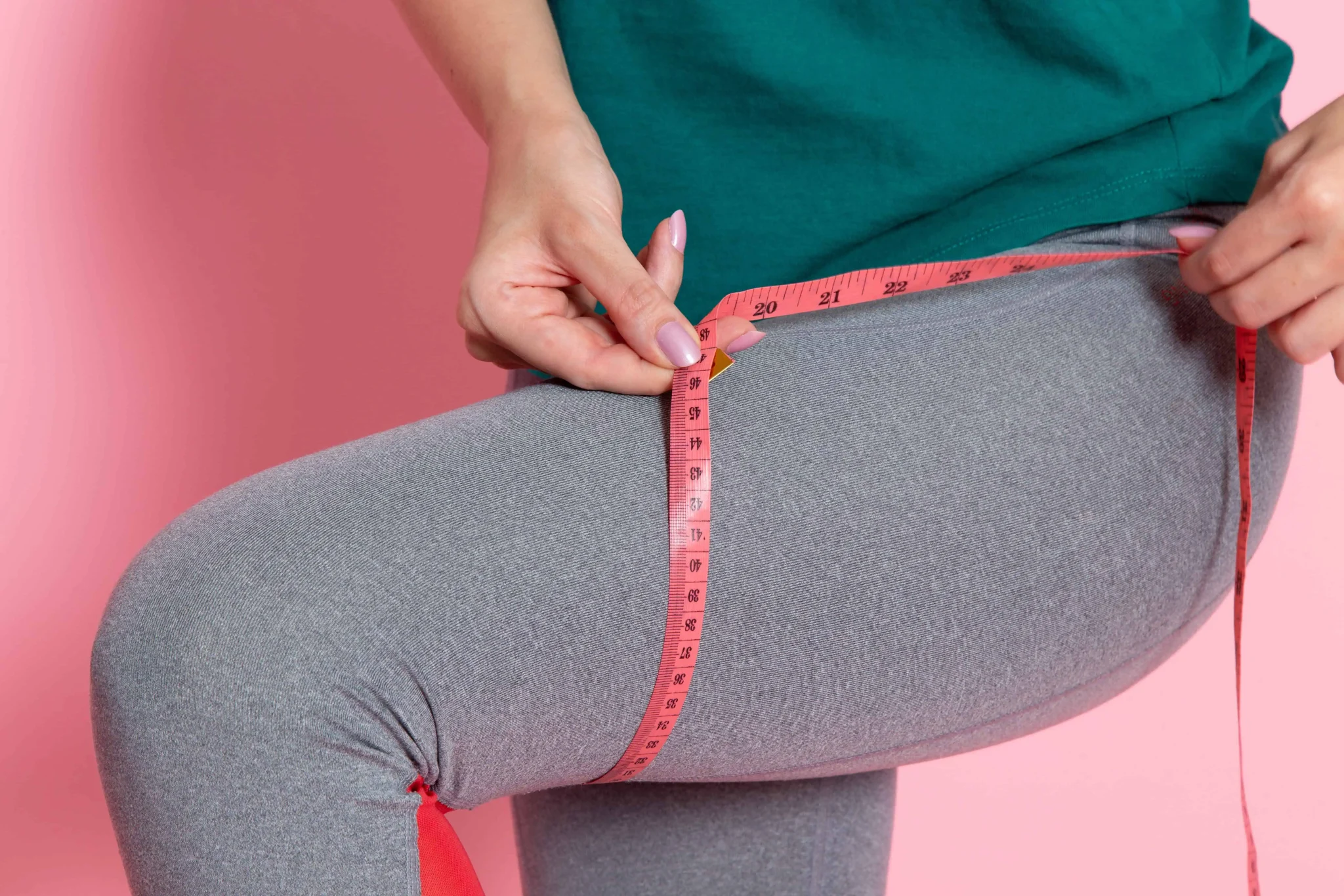 Mujer tomando las medidas de sus piernas